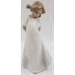 A Lladro Porcelain Figure. Shy Little Daisa. 20cm tall.
