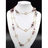 AN 18CT GOLD NECKLACE WITH RUBY AND TAHITION PEARLS MEASURING 125 cms IN LENGTH AND WEIGHING 55.6