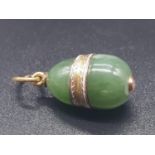 A RUSSIAN 14CT GOLD AND JADE EGG PENDANT WITH A DIAMOND SET IN THE BOTTOM.3.5gms and 1.5cms