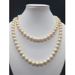 A Belle Epoque Majorca pearl necklace with a 14 carat clasp, on multi silk string with