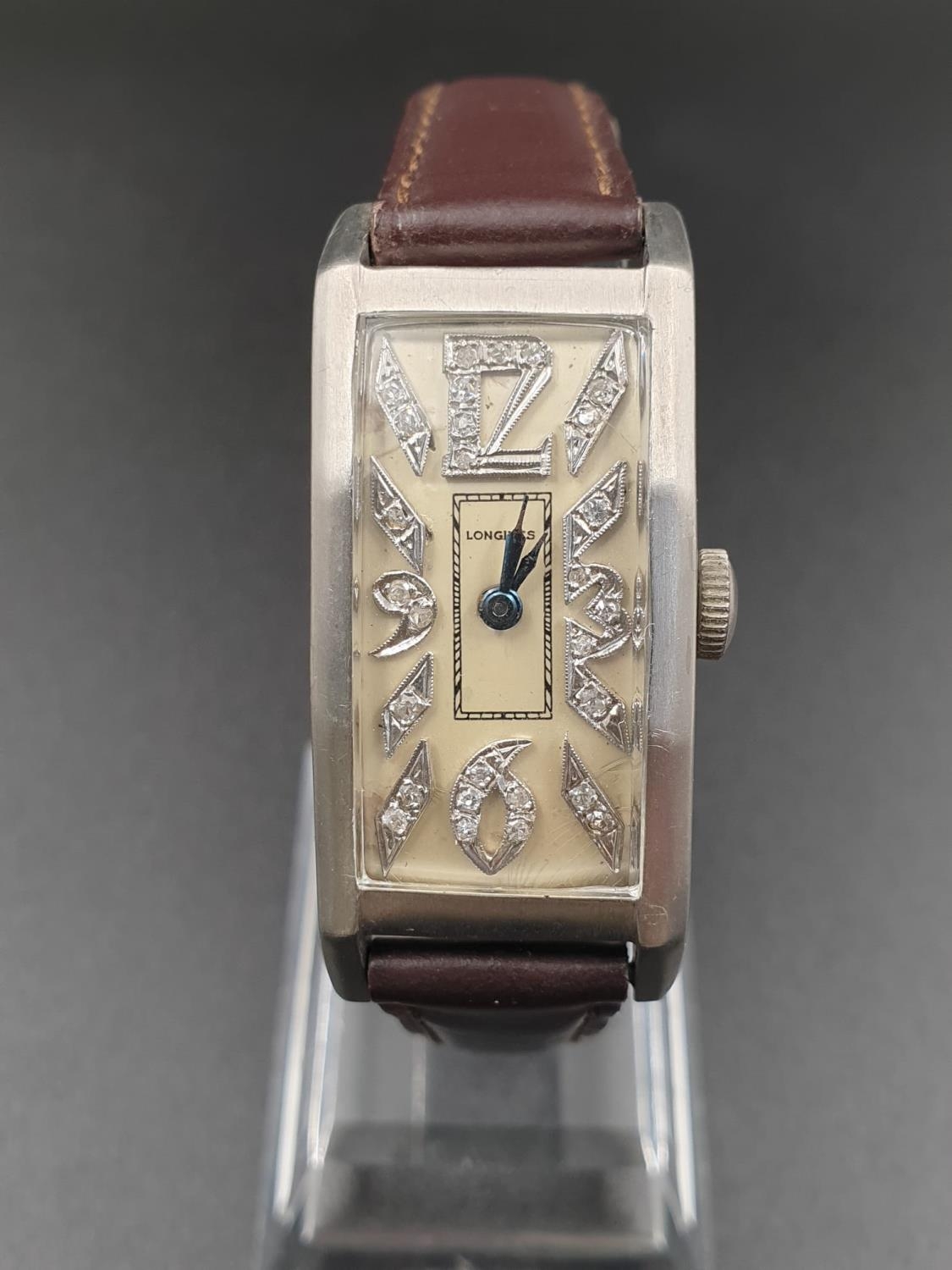 A PLATINUM LONGINES WRIST WATCH WITH DIAMOND NUMBERS. 20mm manual movement.