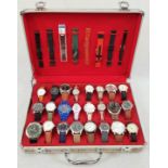 An Assortment of 24 Gents and Ladies watches in a tartan decorated metal case. 8 spare straps.