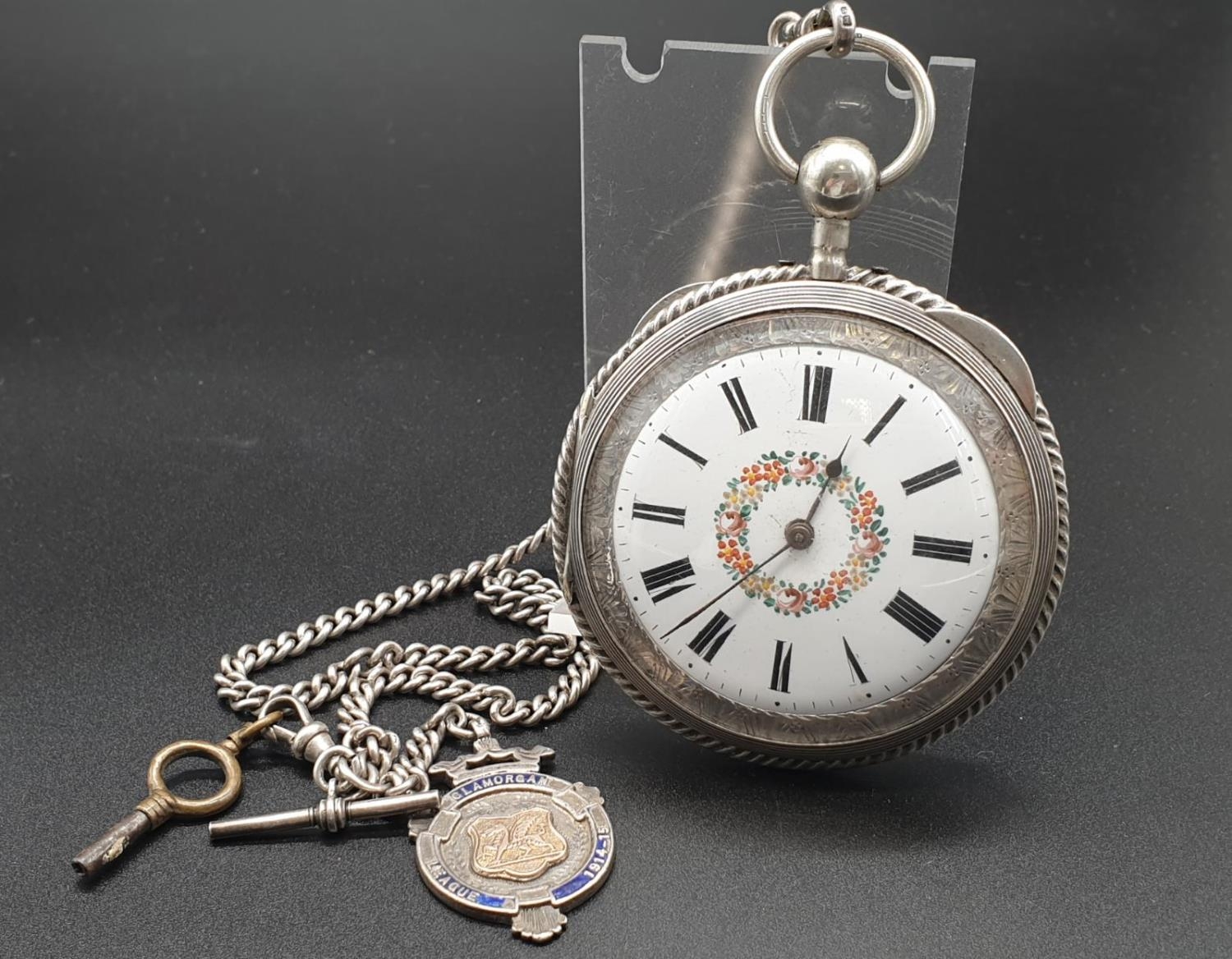 Brilliantly-Crafted Antique Chiming Silver Pocket Watch. Detailed engraving on rear case. White dial