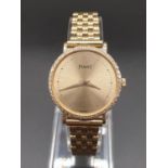 AN 18K GOLD PIAGET LADIES WRIST WATCH WITH DIAMOND BEZEL AND SOLID GOLD STRAP. manual movement 25mm.