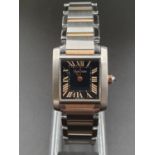 A CARTIER TANK STYLE WATCH WITH BI-COLOURED STAINLESS STEEL STRAP, BLACK FACE WITH ROSE GOLD