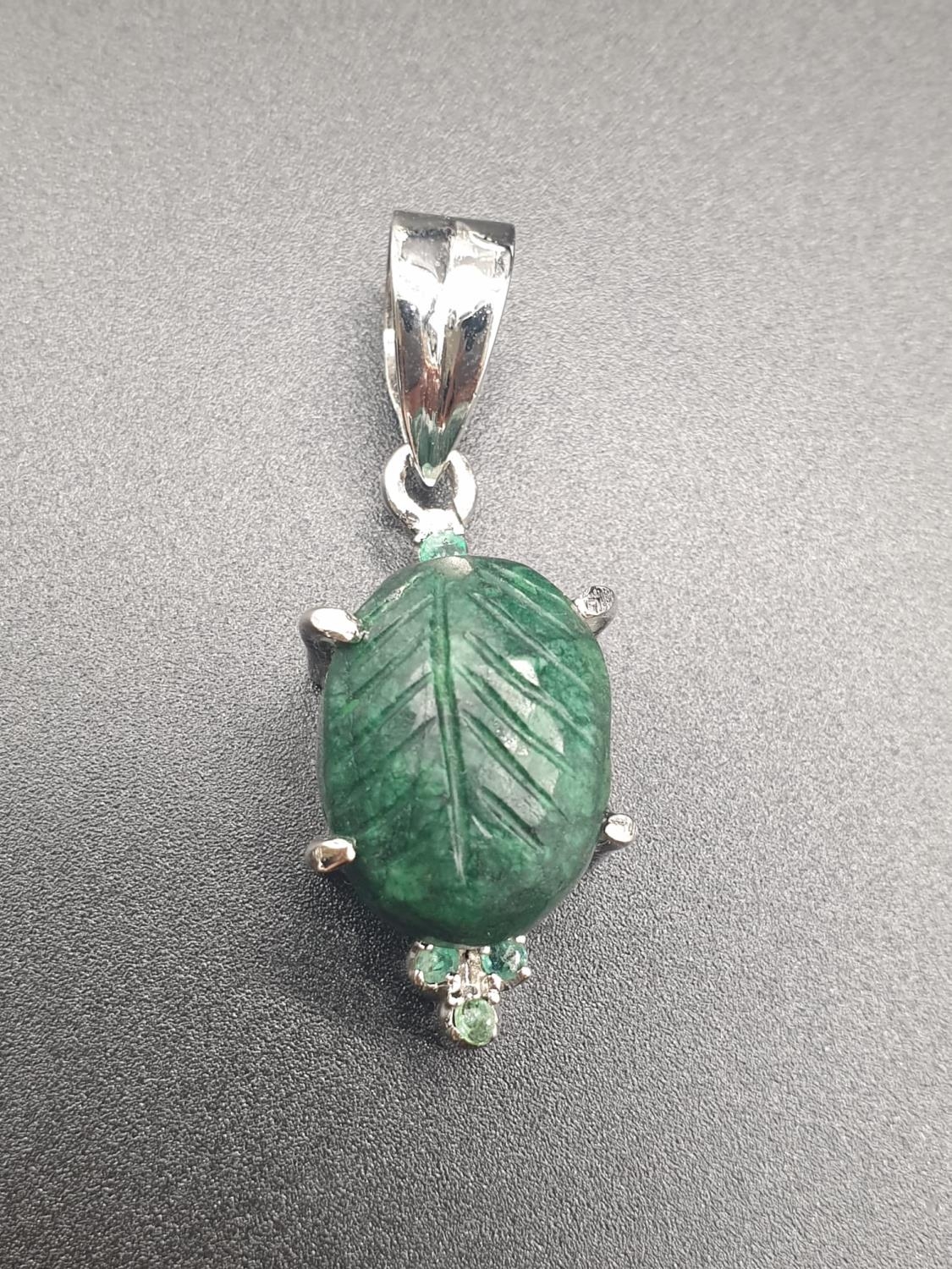 Carved Emerald Oval Pendant set In Sterling Silver, weight 10.65g and 5cm drop approx