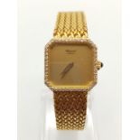 18K GOLD DRESS WATCH BY CHOPARD OF GENEVA WITH DIAMOND BEZEL AND SOLID GOLD STRAP. 20MM