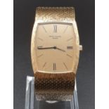 AN 18K GOLD PATEK PHILIPPE DRESS WATCH WITH SOLID GOLD BARKED STRAP. 28MM