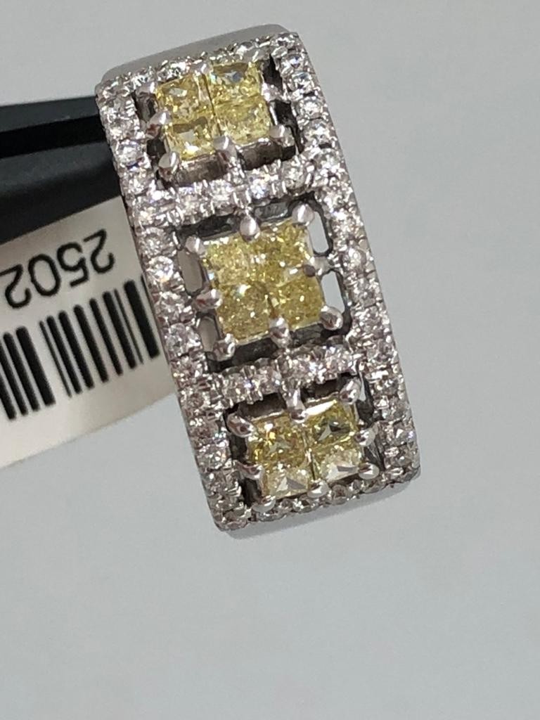 18k white gold ring with white diamonds around 0.50cts and fancy yellow diamonds around 0.70cts;