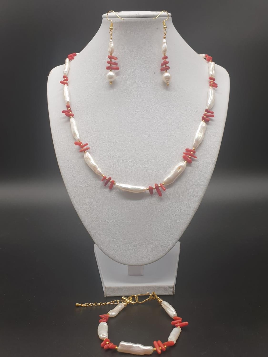 An unusual Biwa pearls and red corals necklace, bracelet and earrings set in a presentation box.