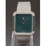AN 18K WHITE GOLD DRESS WATCH WITH HALF DIAMOND BEZEL AND SOLID GOLD STRAP. 26MM