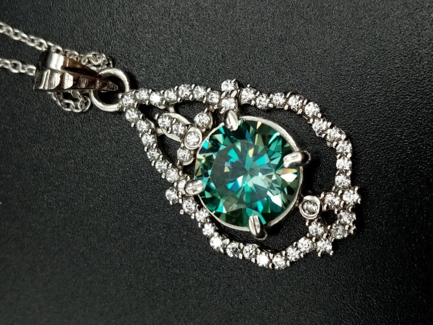 A 3ct blue moissanite gemstone pendant surrounded by white cubic zirconia, mounted in sterling - Image 3 of 7