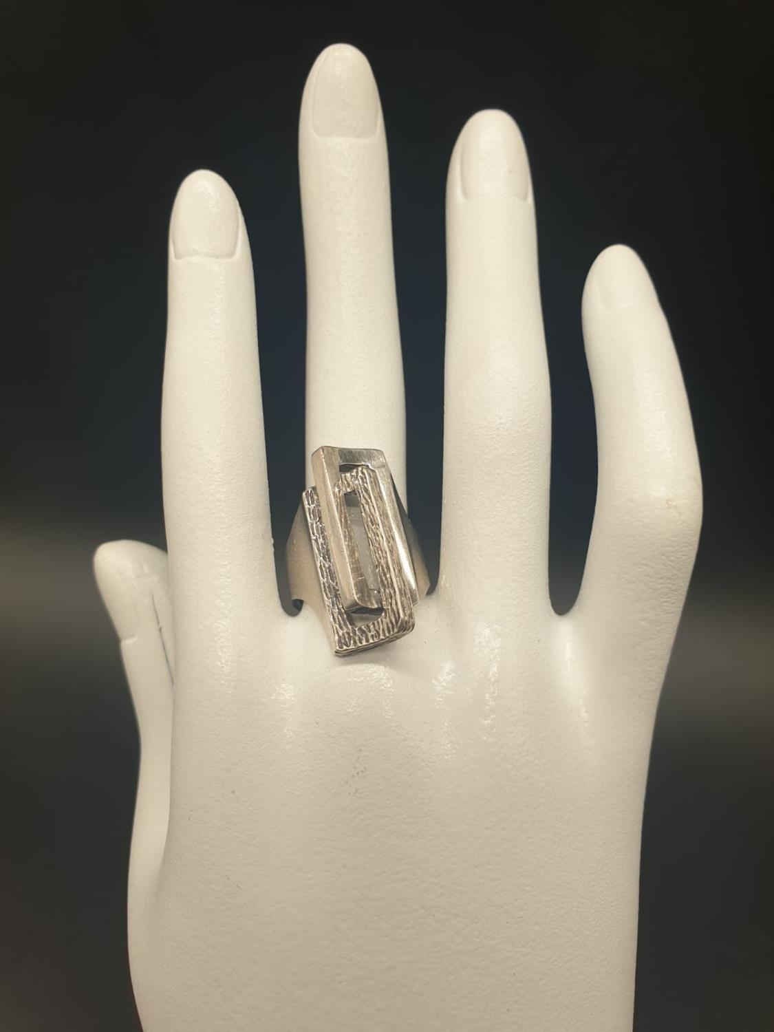 AN UNUSUAL SHAPED SILVER DRESS RING WITH TWO RECTANGULAR SHAPES INTERLOCKED. 8.6gms size N/M - Image 6 of 6