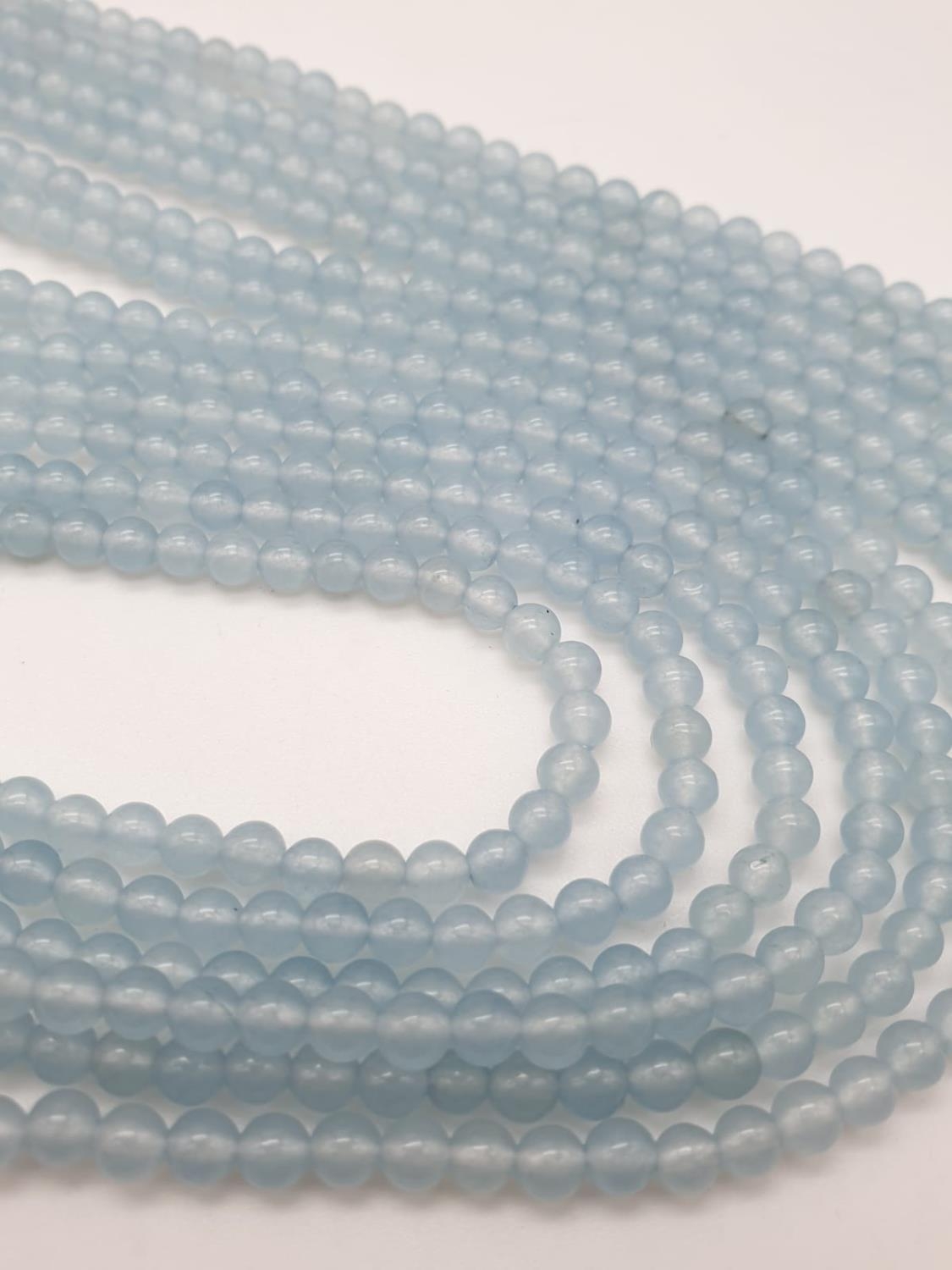 Three very long rows (128cm!) of aquamarine (colour enhanced) and natural pearls that can form a - Image 5 of 10
