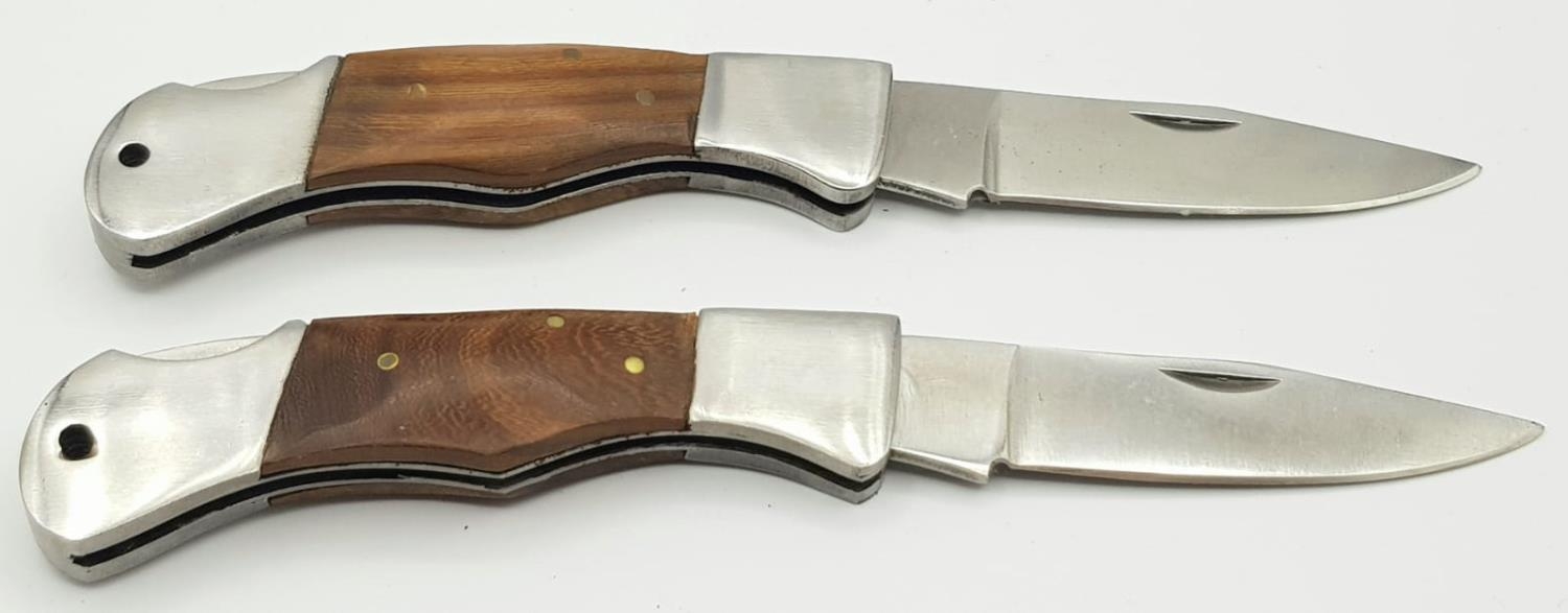 Two quality hardwood handled lock knives. 12 cm in length.