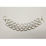 A DOUBLE ROW SILVER BRACELET MARKED AS TIFFANY WITH T-BAR FASTENER. 97.3gms 18cms