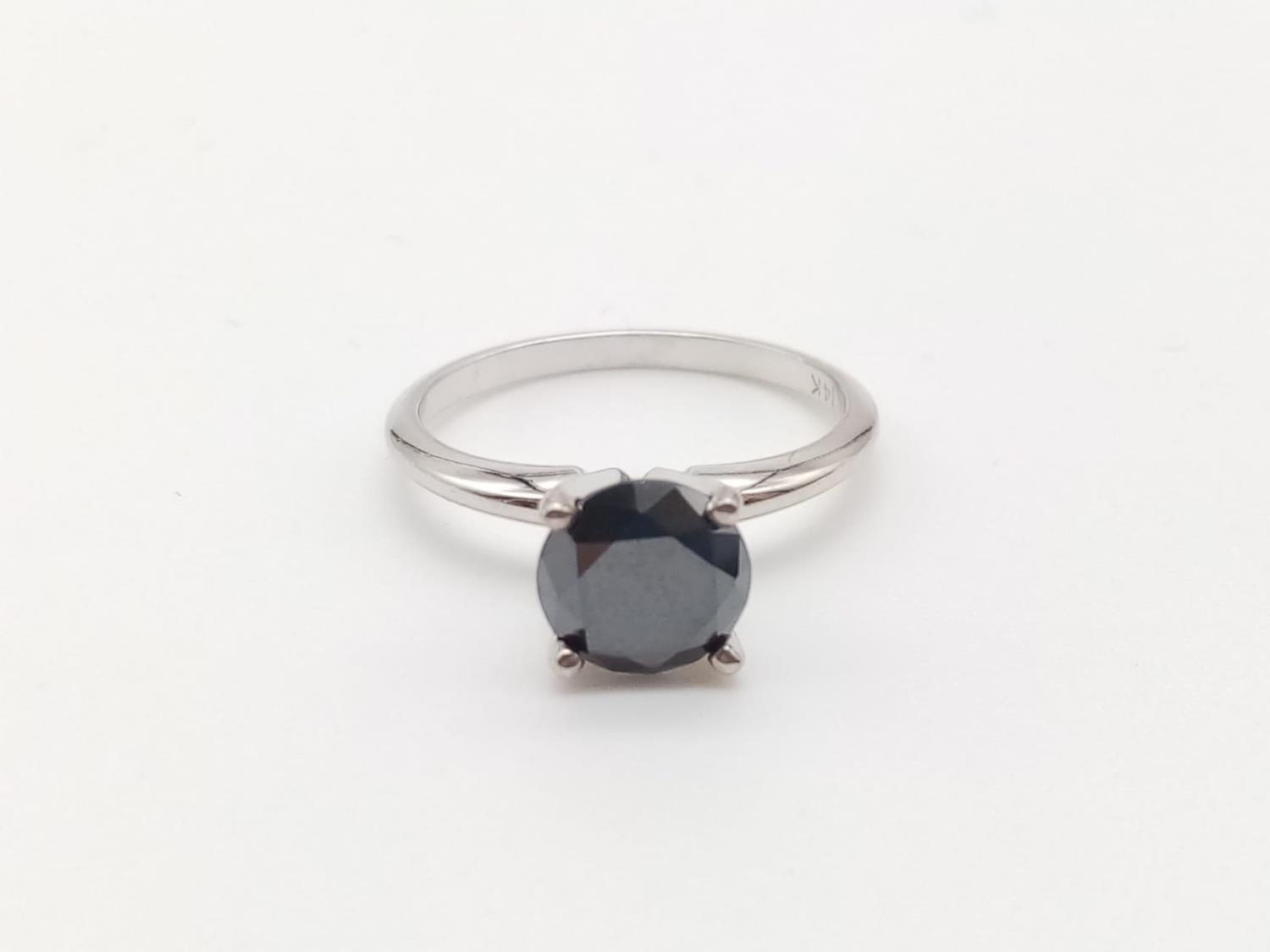 Black diamond solitaire ring set in 14k white gold, weight 2.5g and size K1/2