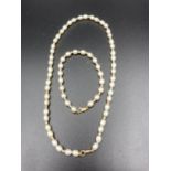 9 carat gold and faux pearl twinset consisting necklace and bracelet having pearls interspaced