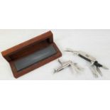 Two Multi-Purpose Metal Pen Knives with a wooden-cased Knife Sharpening Block.
