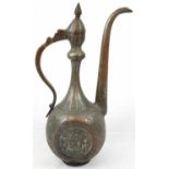 An antique copper ewer with silver overlay with Farsi calligraphy and naturalistic images engraved