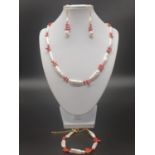An unusual Biwa pearls and red corals necklace, bracelet and earrings set in a presentation box.
