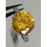 silver ring with Amber cz; size L; 4.9g; the centre stone around 11mm in diameter