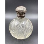 Antique large globe shaped cut glass scent bottle having original stopper and silver repousse