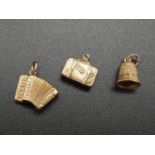 Three 9K Yellow Gold Charms. A Bell, Suitcase and an Accordion. 2.24g