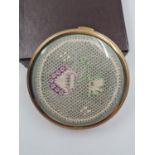 A Vintage Enamel Compact. Woven floral design on lid. 7cm diameter. Good Condition.