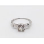 Platinum diamond solitaire ring with further diamonds on shoulders, weight 3.4g and approx over
