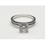 STERLING SILVER CZ SOLITAIRE RING WITH CZ SHOULDERS. SIZE L. 2.2g