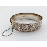 Vintage Silver Bangle. Decorative engraving on one side. 6cm diameter. 56.87g