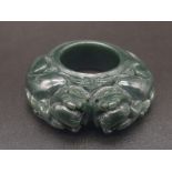 A very collectable, Chinese archaic style, dark green jade, carved ring, decorated with two fu dogs.