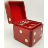 A small, dice shaped, wooden, jewellery box with contents, including Examples of jade, agate,