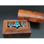 A wonderful wooden trinket box containing an aquamarine ring and earrings set. Ring size: N