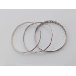 Three Silver Bangles. Different Thicknesses and decorations. 21.39g total weight. 6.5cm diameter.