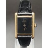 Must de Cartier ladies wristwatch with black square face, gold plate and leather strap, 26mm x 20mm