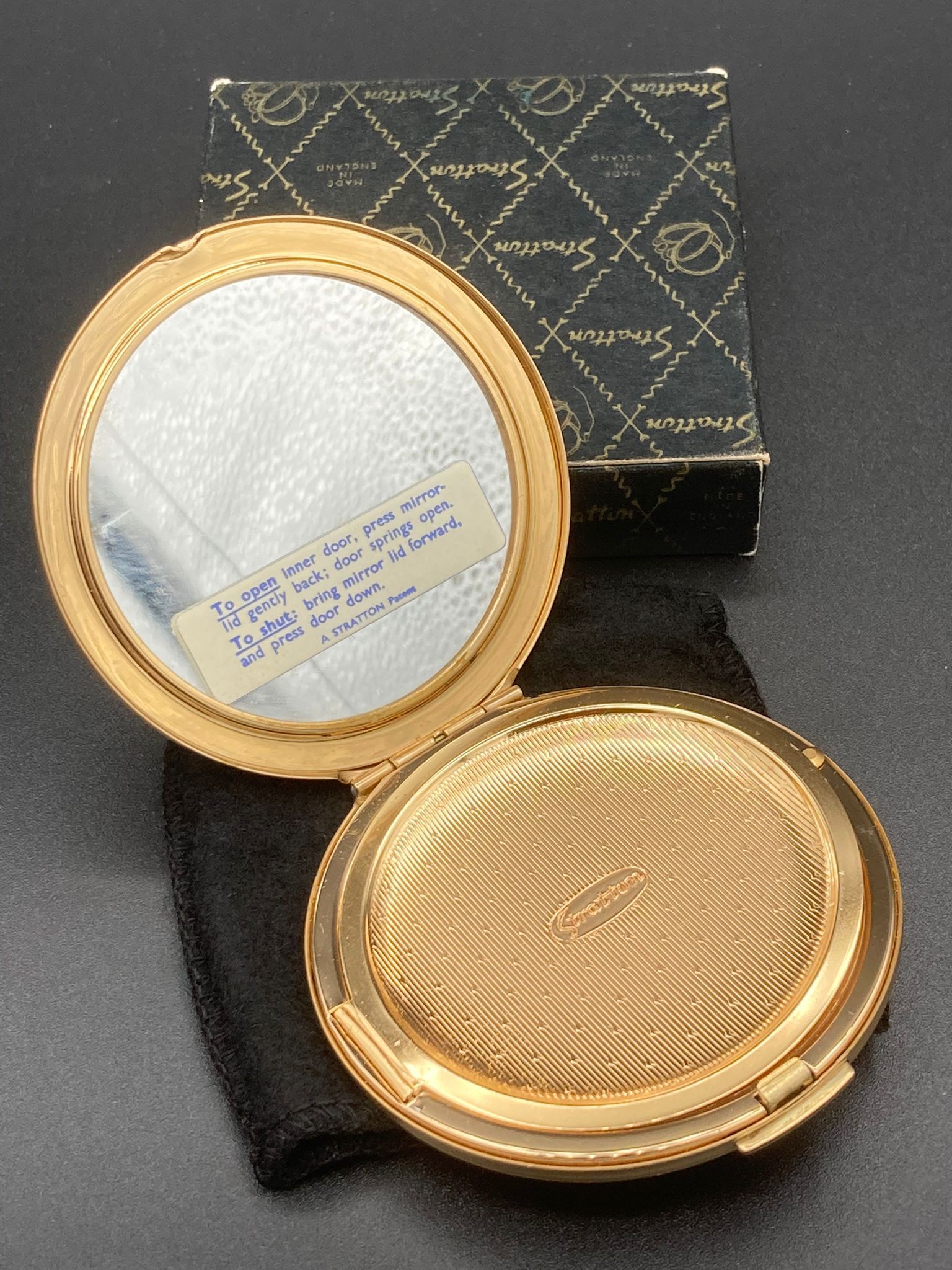 Vintage Stratton compact ,new and unused condition ,having chased floral design work lid and