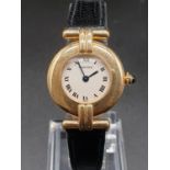 18k yellow gold Cartier quartz ladies watch, white round face and black leather strap, 23mm