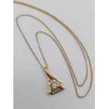 14k yellow gold pendant with round and baguette diamonds on 50cm long 14k gold chain, weight 4.2g