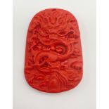 A Chinese Dragon Hand-Carved Coral Pendant.