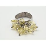 A Silver Ring with Multiple Miniature Yellow-Stone Attachments. Size P (expandable). 7.43g