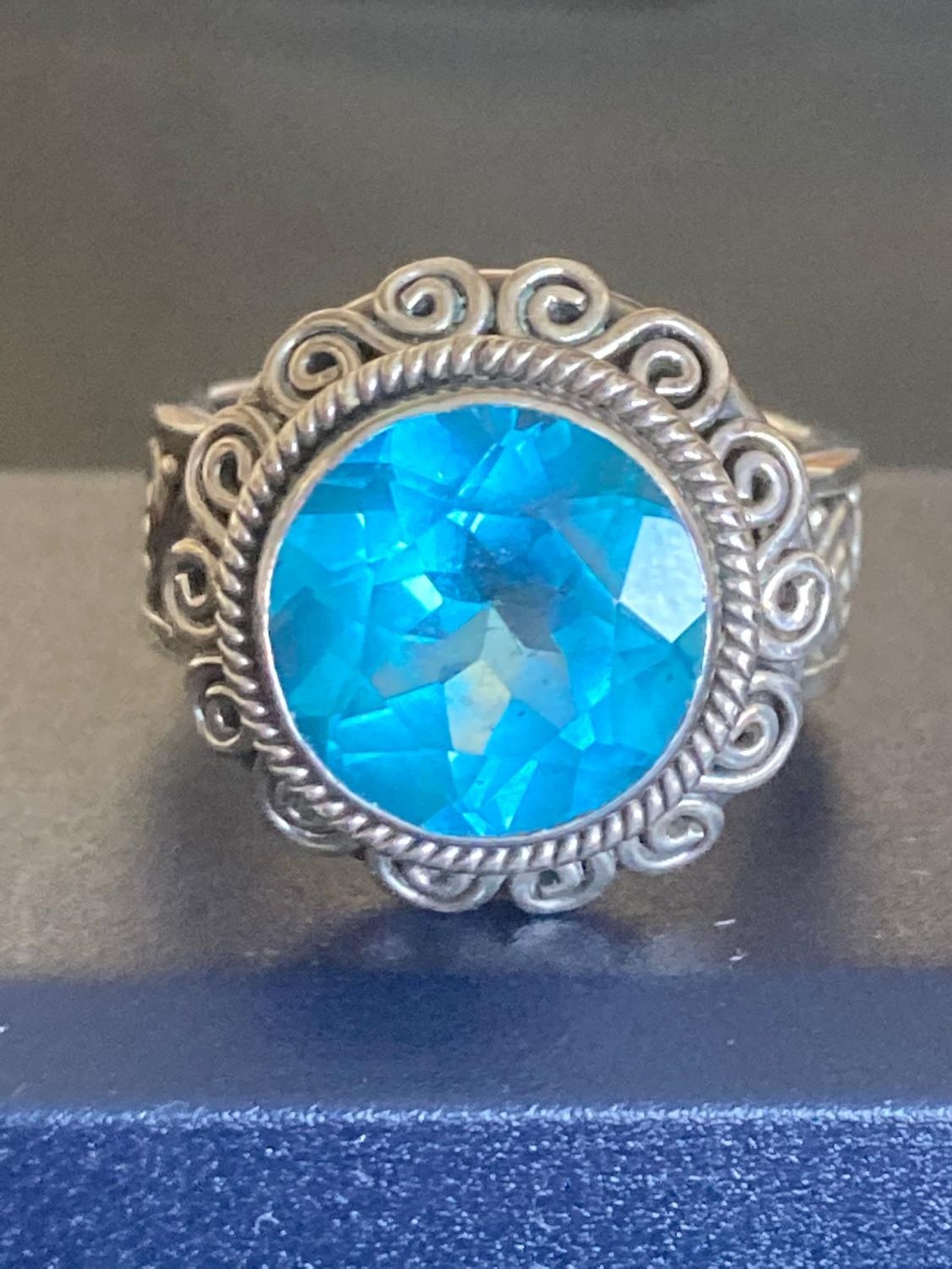 Silver and Topaz Ring having large Swiss Blue Topaz. Scroll detail to surround and band. 925 - Image 2 of 2
