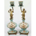 A PAIR OF FRENCH VICTORIAN COLD PAINTED CANDLESTICKS HAND DECORATED WITH BRASS CHERUBS HOLDING THE