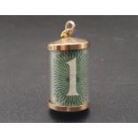 A VINTAGE 9K GOLD CHARM/PENDANT WITH A £1 NOTE FOLDED INSIDE THE CAPSULE. 2.9gms 2cms