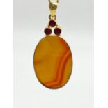 A Silver Gilt Agate and Ruby Oval Pendant. 14.8g