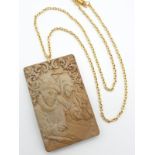 An antique, hand engraved in great detail jasper stone pendant depicting a pair counting money and