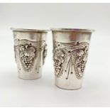 A Pair of Silver Kiddush Cups. Ornate Grape Decoration. 5cm tall. 47g