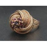 14K Yellow Gold Fancy twist Garent set ring. Weighs 7g. Size K.