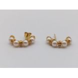A Pair of 18k Yellow Gold Half-Hoop Pearl Earrings. Four small natural pearls on each earring. 3.28g
